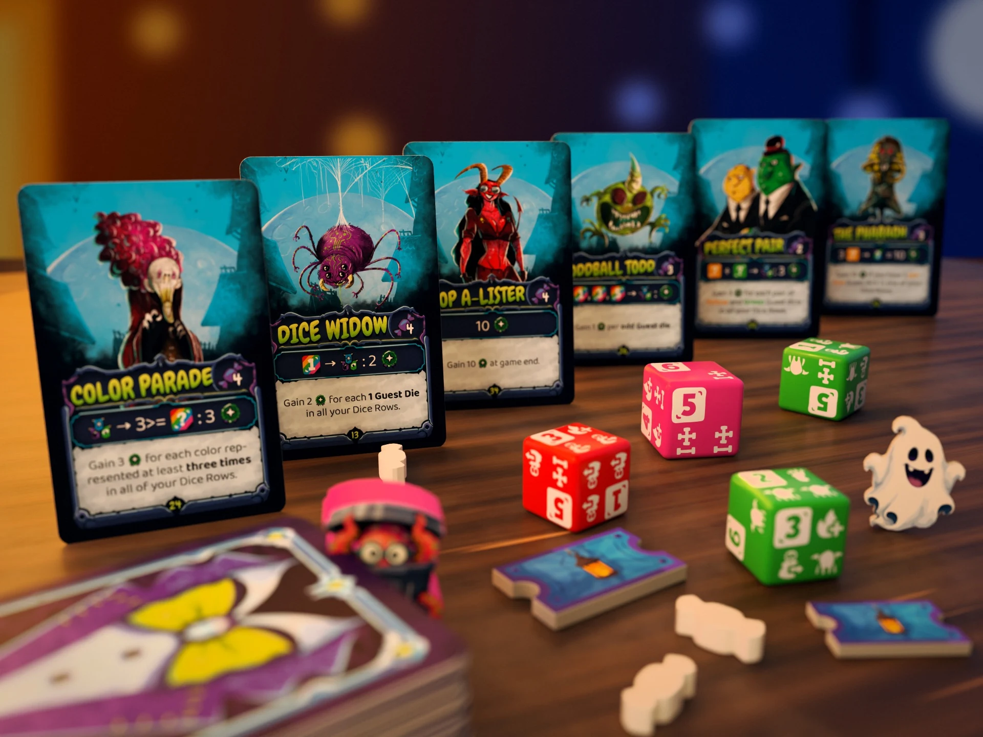 A row of illustrated cards including Color Parade and Dice Widow, with colorful Guest Dice in front