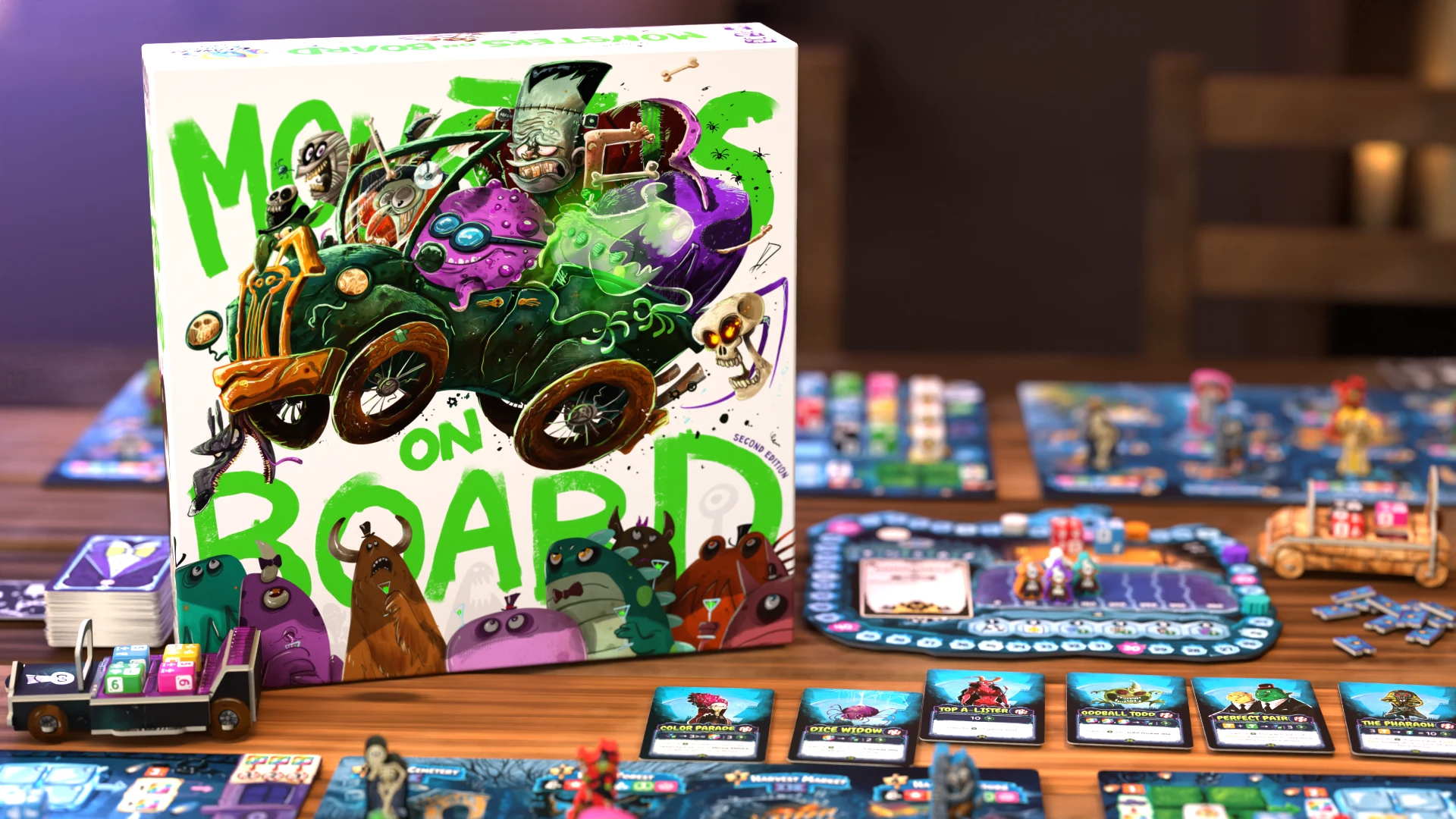 Monsters on Board: Second Edition box beside player boards, colorful dice, cards, and Fearmobiles