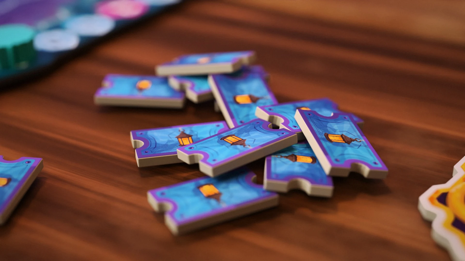 Blue and purple ticket tokens decorated with glowing lanterns on a wooden table